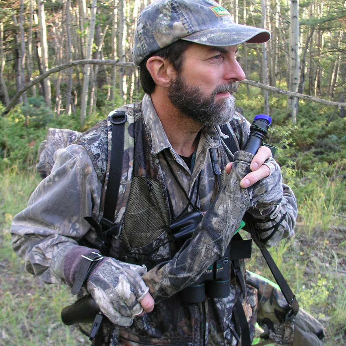 Hunter in camo carrying the Primos Terminator Elk System in the forest