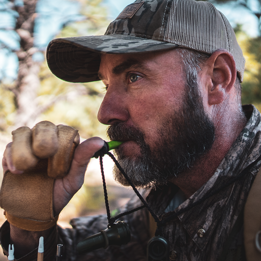 Hunter using the Primos Cow Girl Elk Call while bowhunting