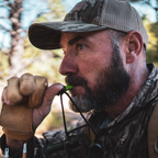 Hunter using the Primos Cow Girl Elk Call while bowhunting