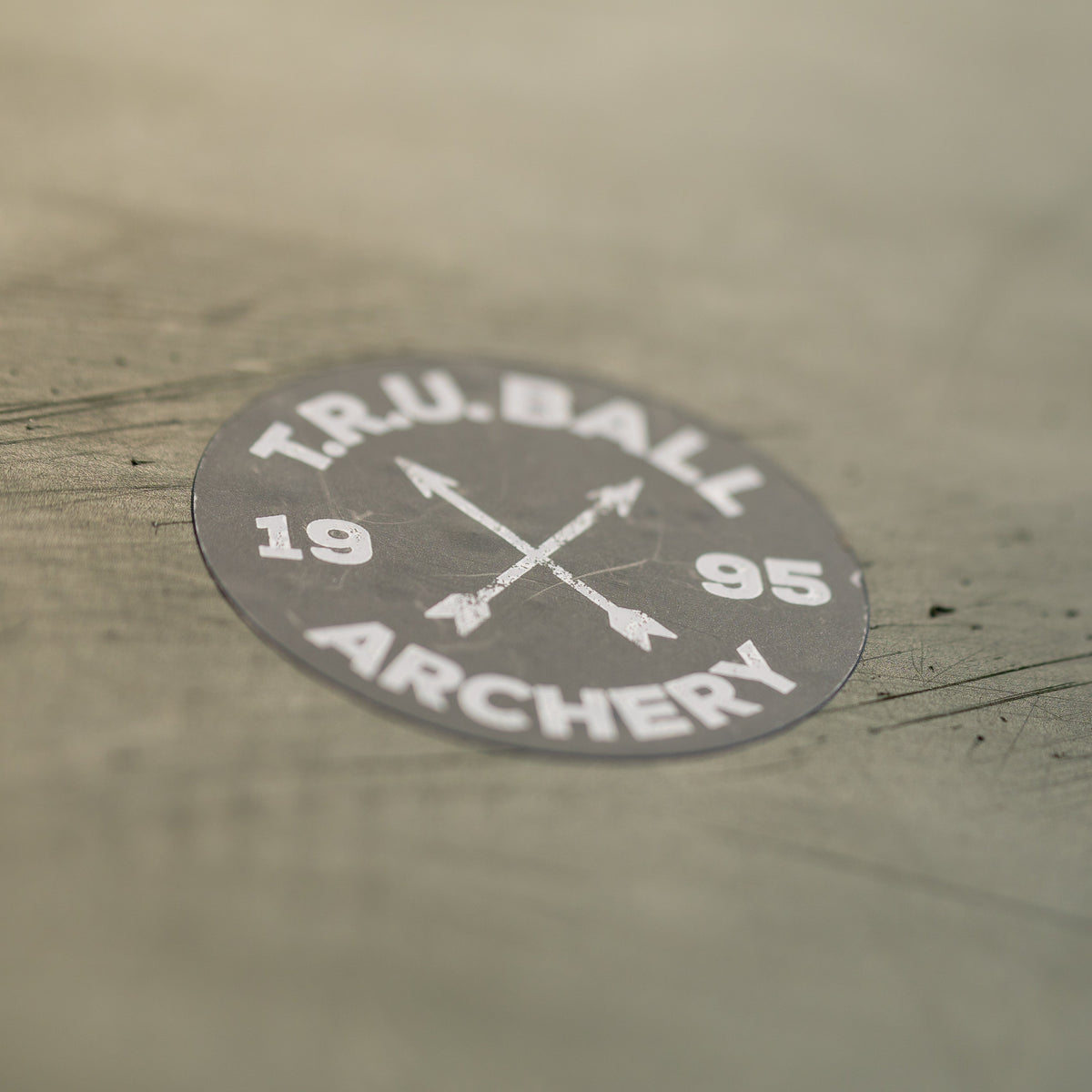 T.R.U. Ball Circle X Arrows sticker applied to a work surface