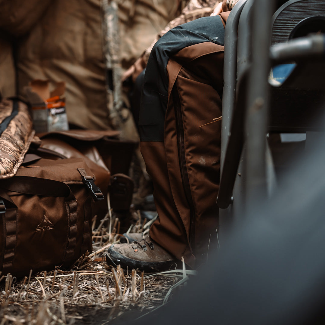 SKRE Ambush Bib in Layout Brown worn in a blind