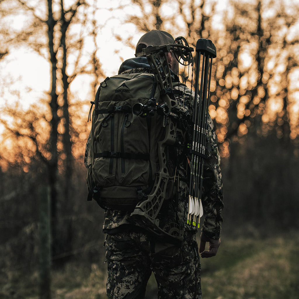 SKRE Timberline 2400 Pack worn with a compound bow on the quick-release weapon mount