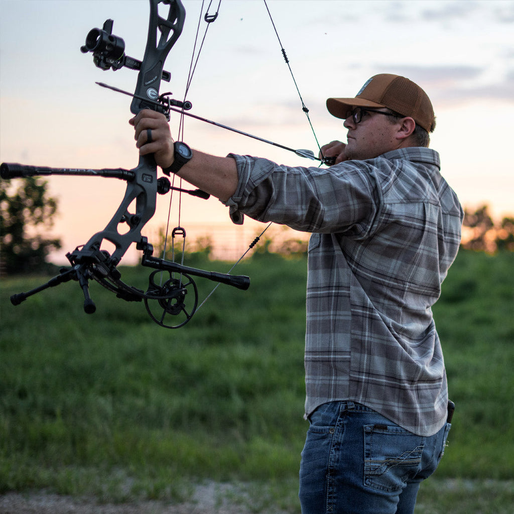SKRE Delta Flannel Top worn at full draw on the practice range