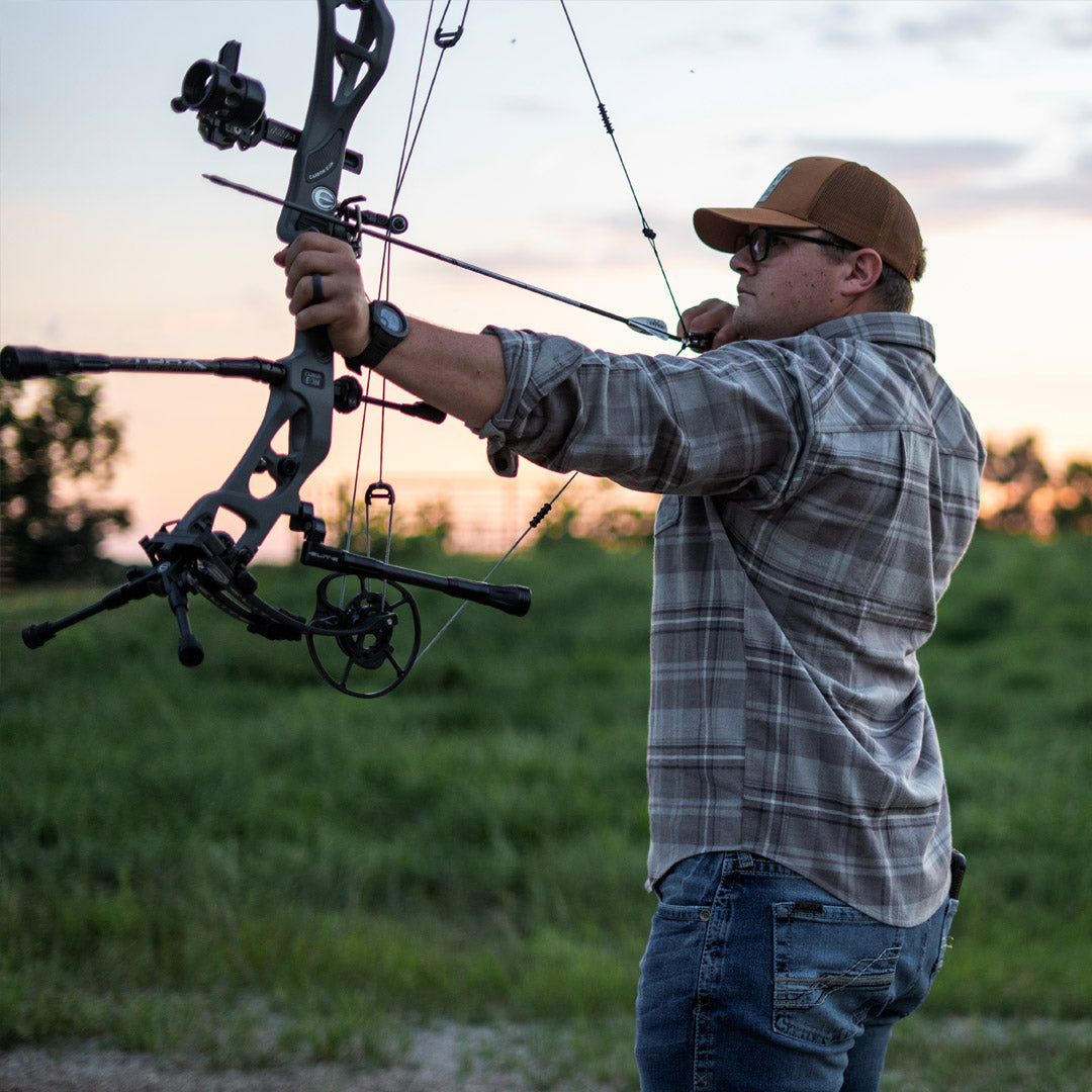 SKRE Delta Flannel Top worn at full draw on the practice range