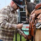 SKRE Delta Flannel Top worn saddling a horse