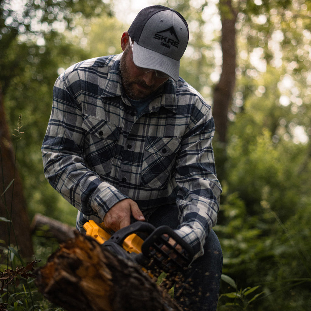 SKRE Delta Flannel Top worn cutting firewood
