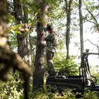 SKRE Venture Flex Pant worn hanging a trail camera