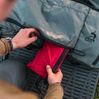 Stone Glacier First Aid Kit, red pocket being pulled from a pack in the field