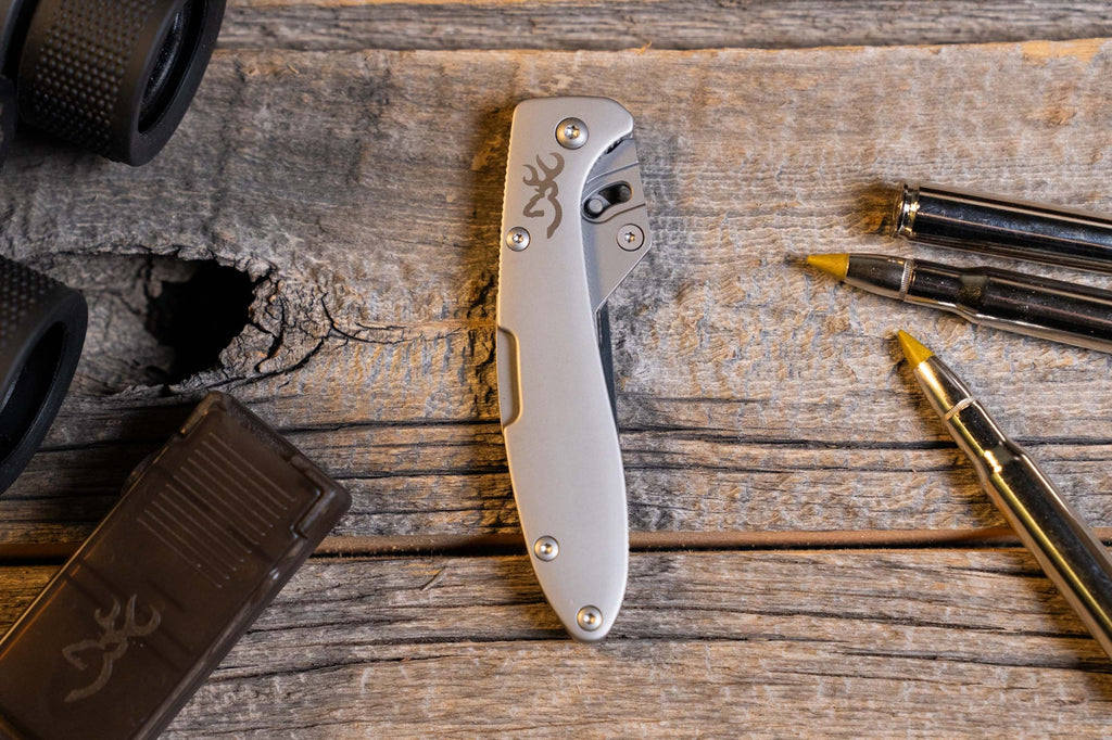 Browning Stainless Scalpel on a weathered wood bench with blade dispenser