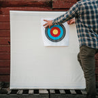 Archer pinning a FITA face to the K9 archery target