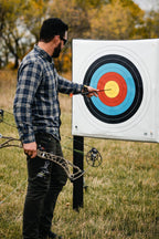 Archer pulling arrows from the RangeDog PLUS outdoor stand