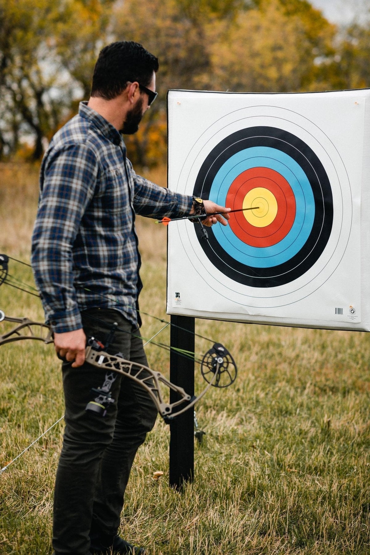 Archer pulling arrows from the RangeDog PLUS outdoor stand