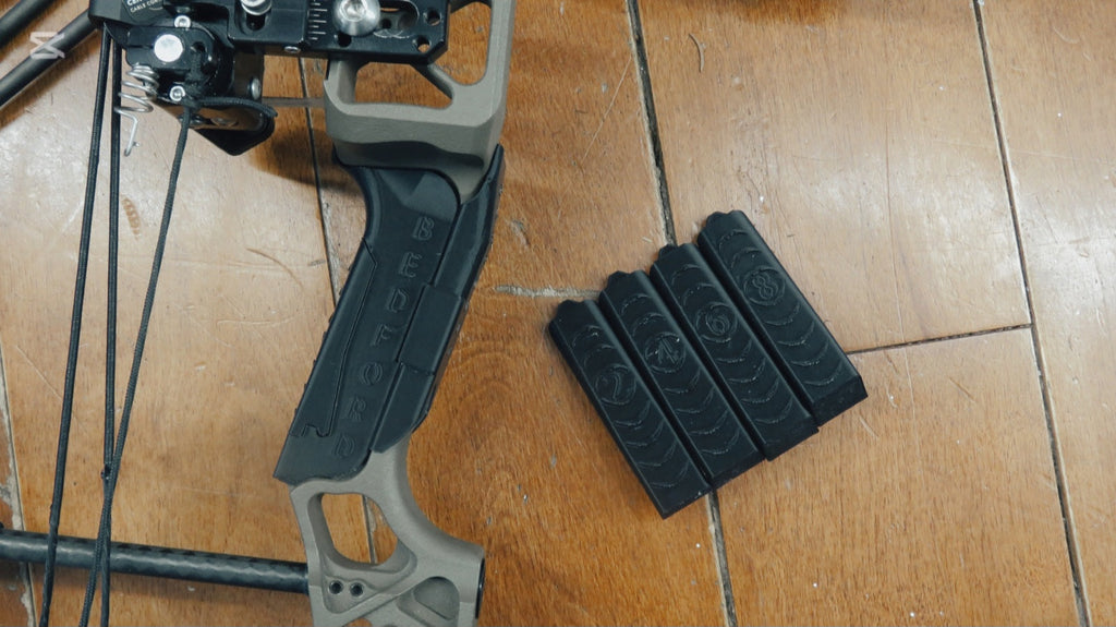 Bedford Archery Mathews grip and backings beside a Mathews riser