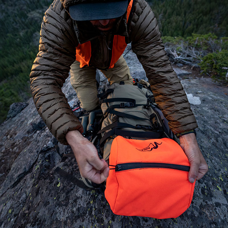 Stone Glacier Sky Series Lid, Blaze Orange being fitted to a pack