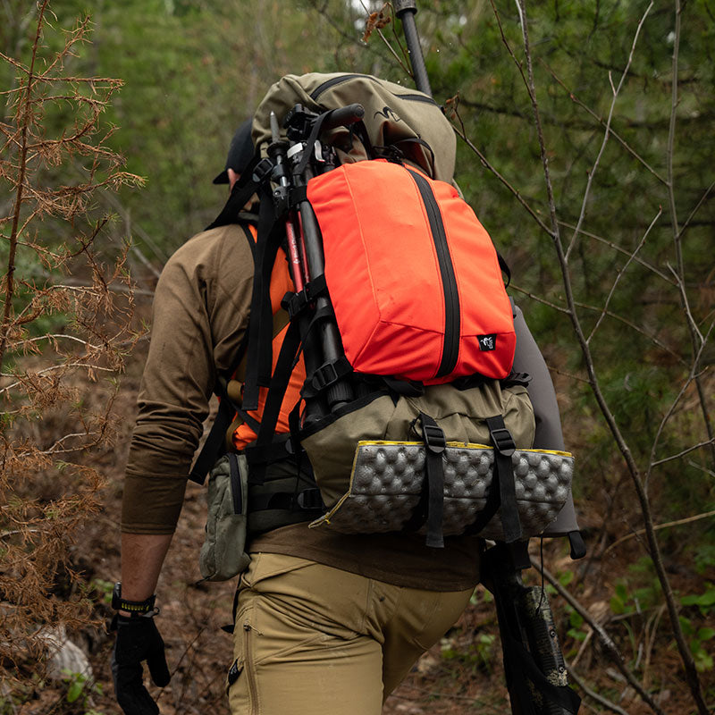 Stone Glacier Access Bag, Blaze Orange, attached to a pack in the field